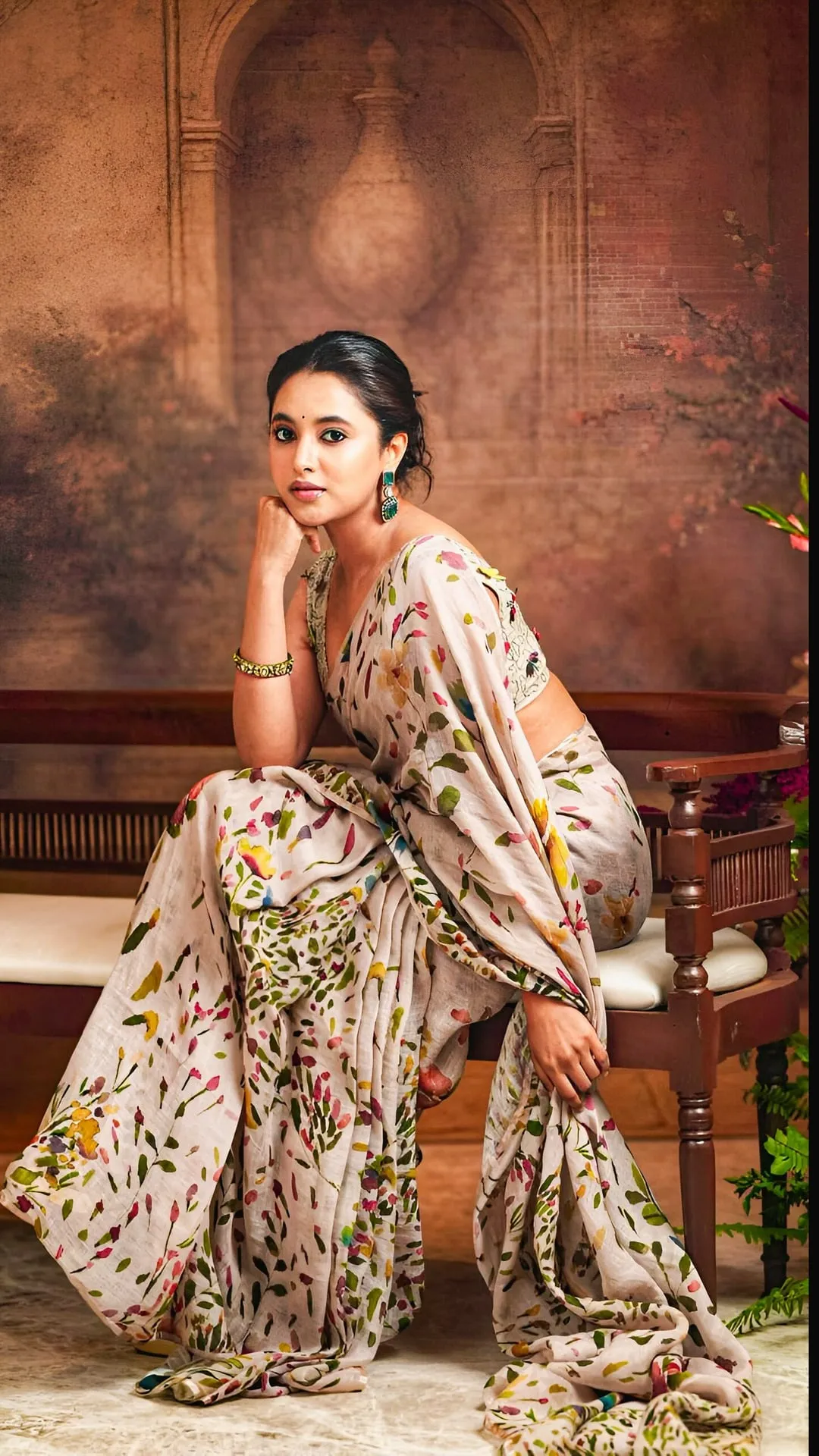 Priyanka Mohan in a White Floral Saree Sitting on the Bench