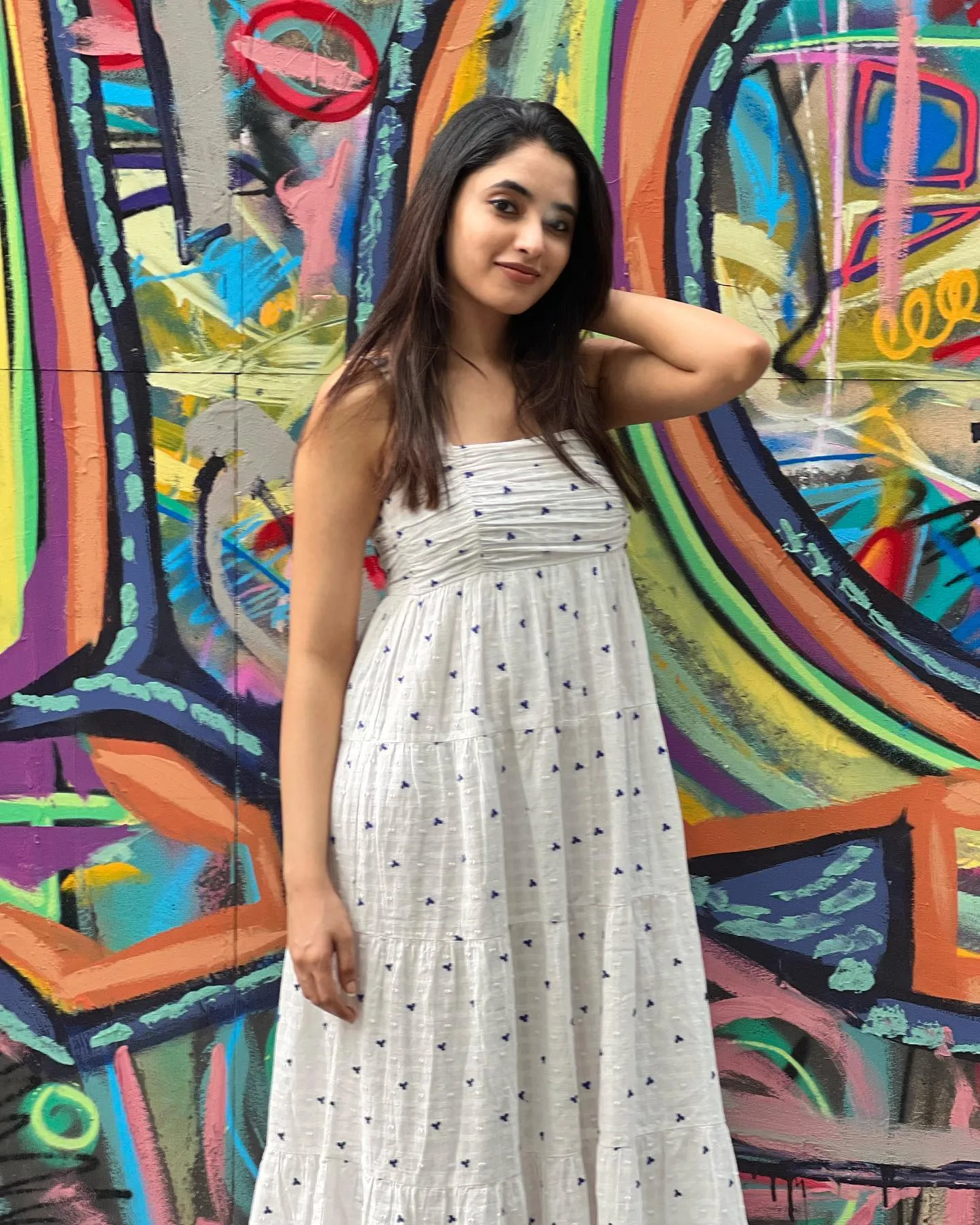 Priyanka Mohan in a White Outfit Standing Near Artistic Wall