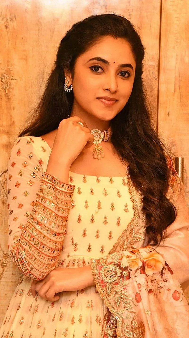 Priyanka Mohan in a Yellow Dress Standing on the Studio Wall