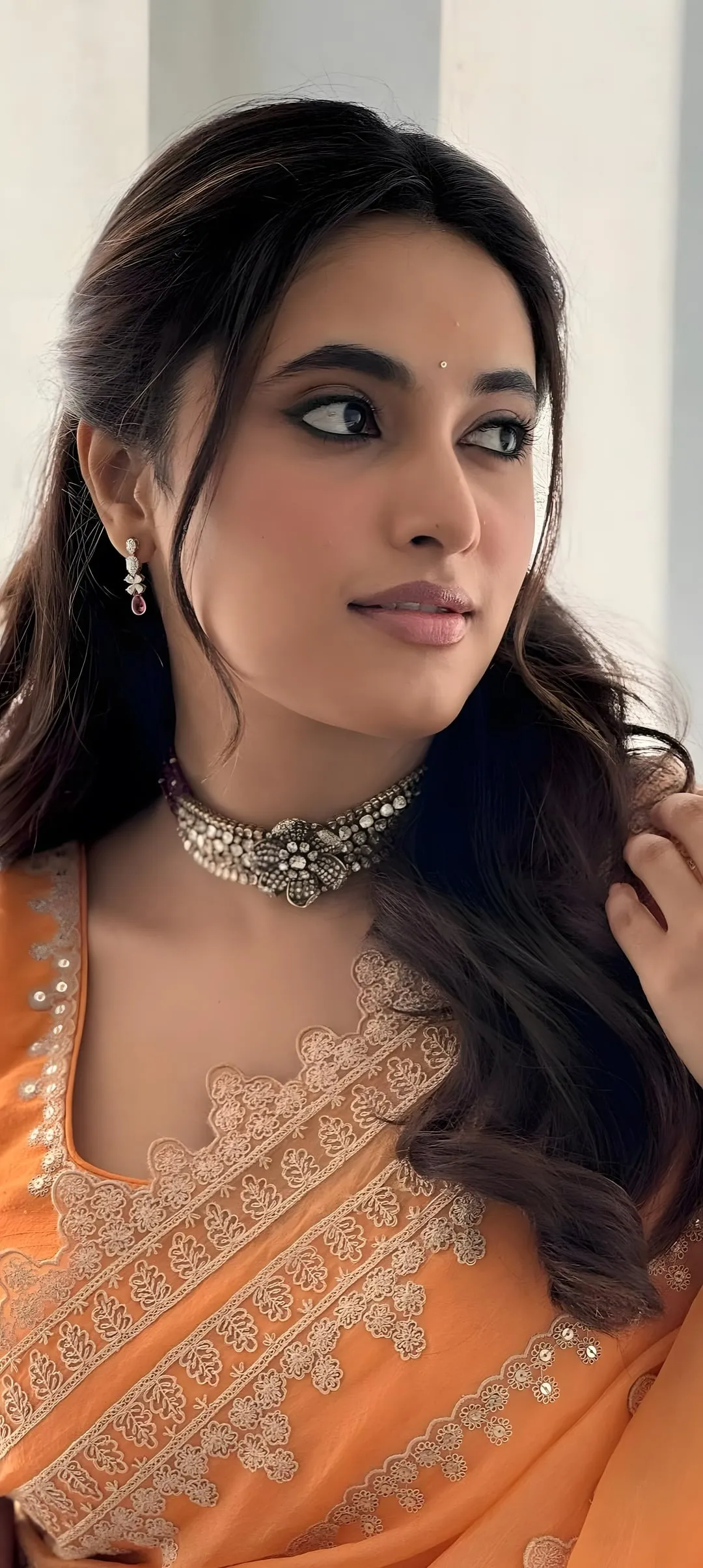 Priyanka Mohan in an Orange Saree Looking at the Side Image