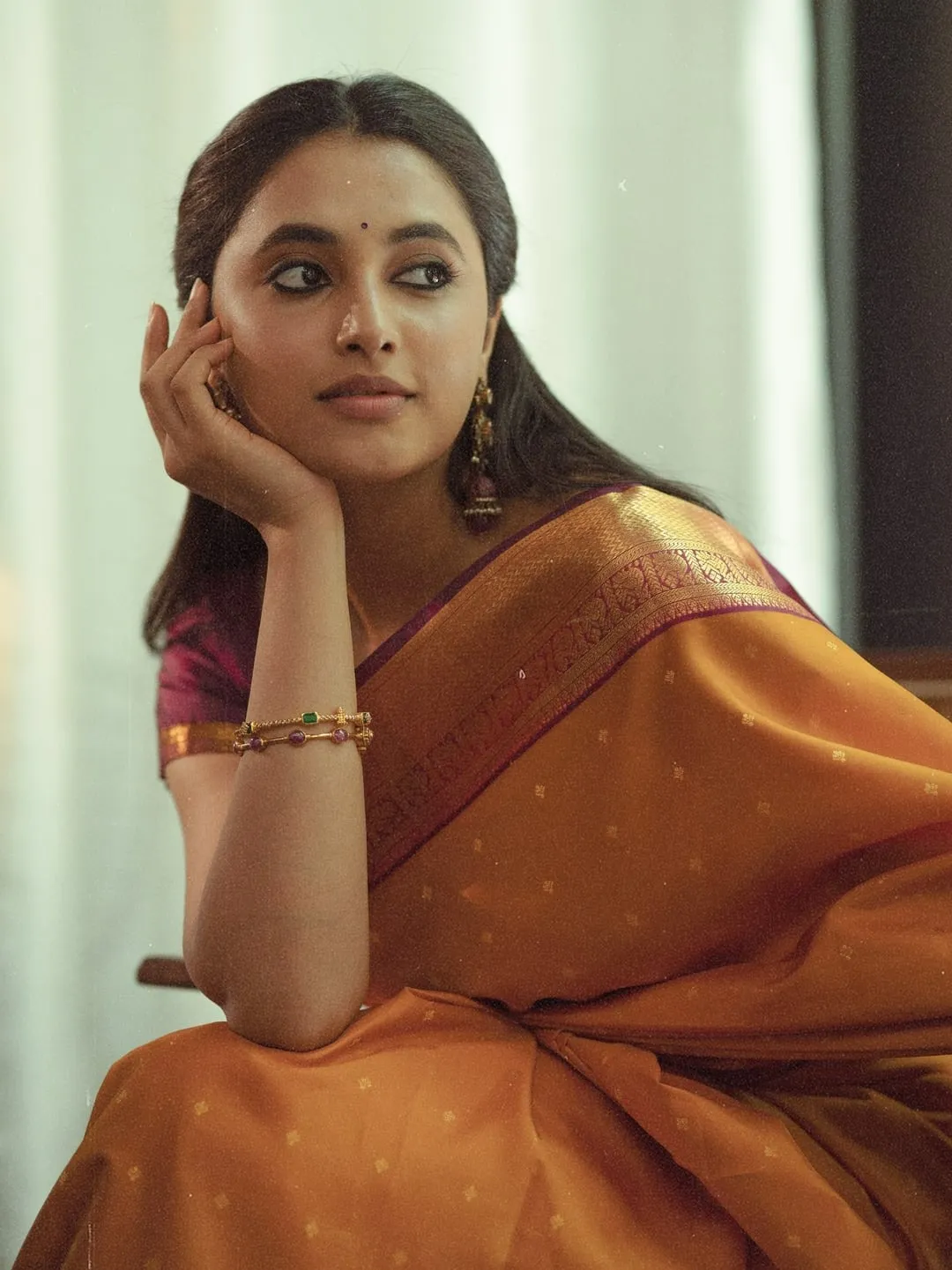 Priyanka Mohan in an Orange Saree Sitting in the Studio