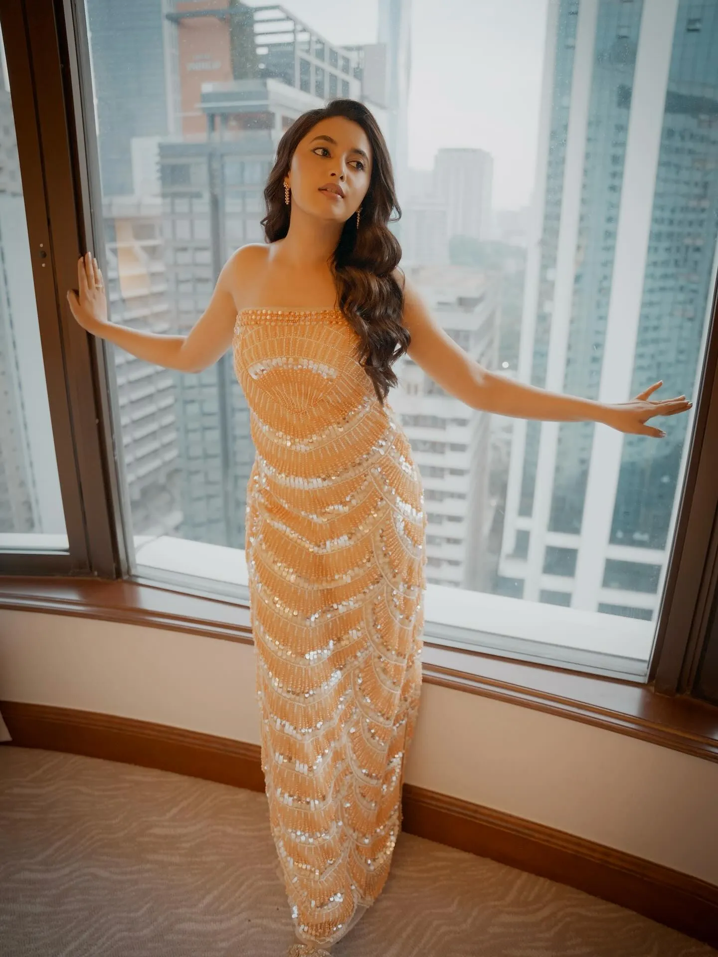 Priyanka Mohan in an Orange Saree Standing Near the Window