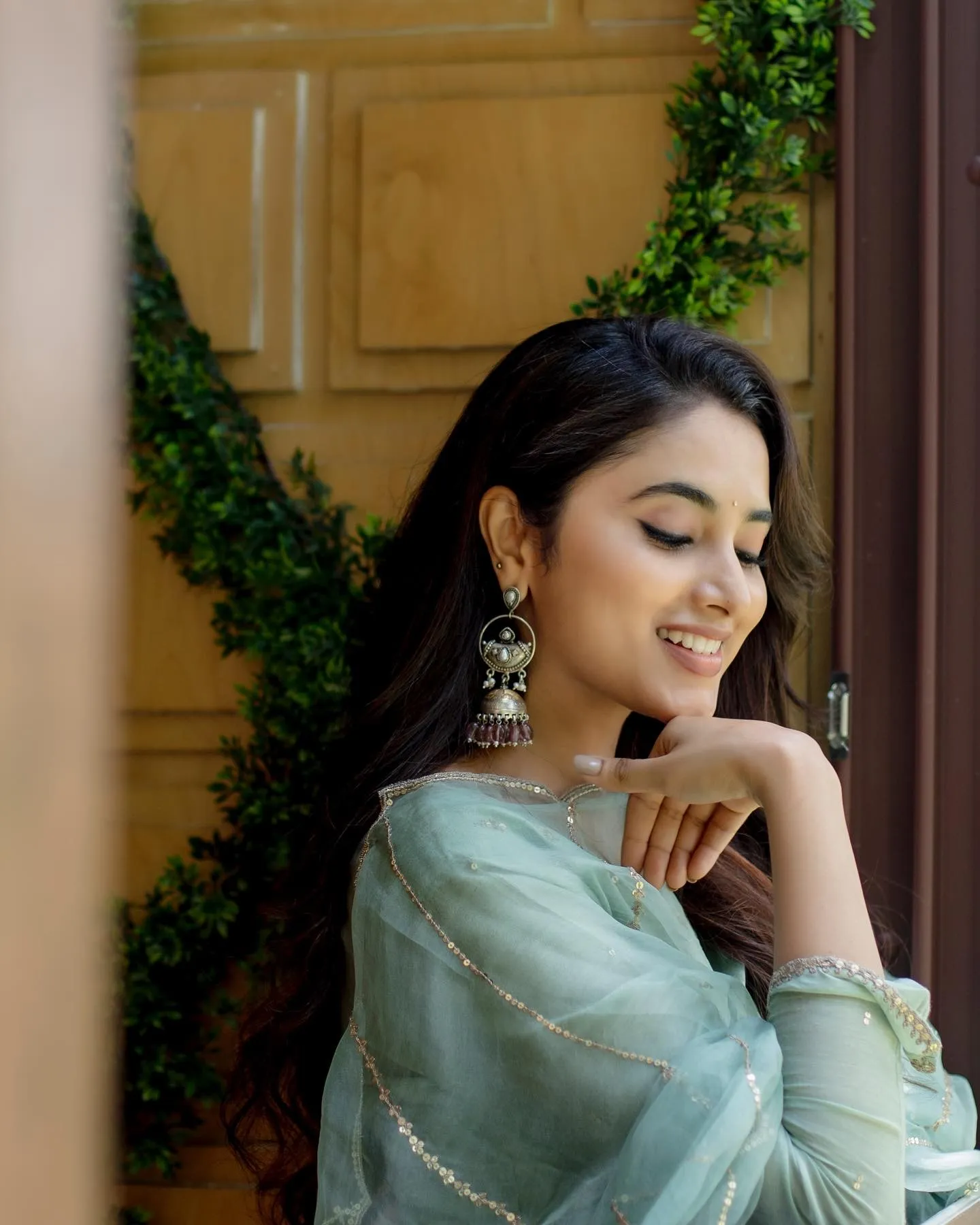 Priyanka Mohan in Blue Dress Standing Near the Wooden Door