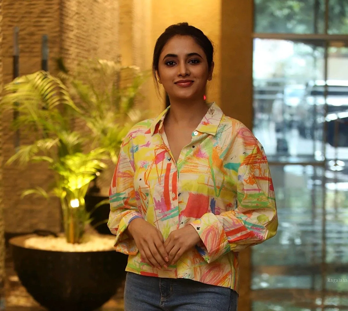 Priyanka Mohan in Colourful Dress Standing Near Small Plant