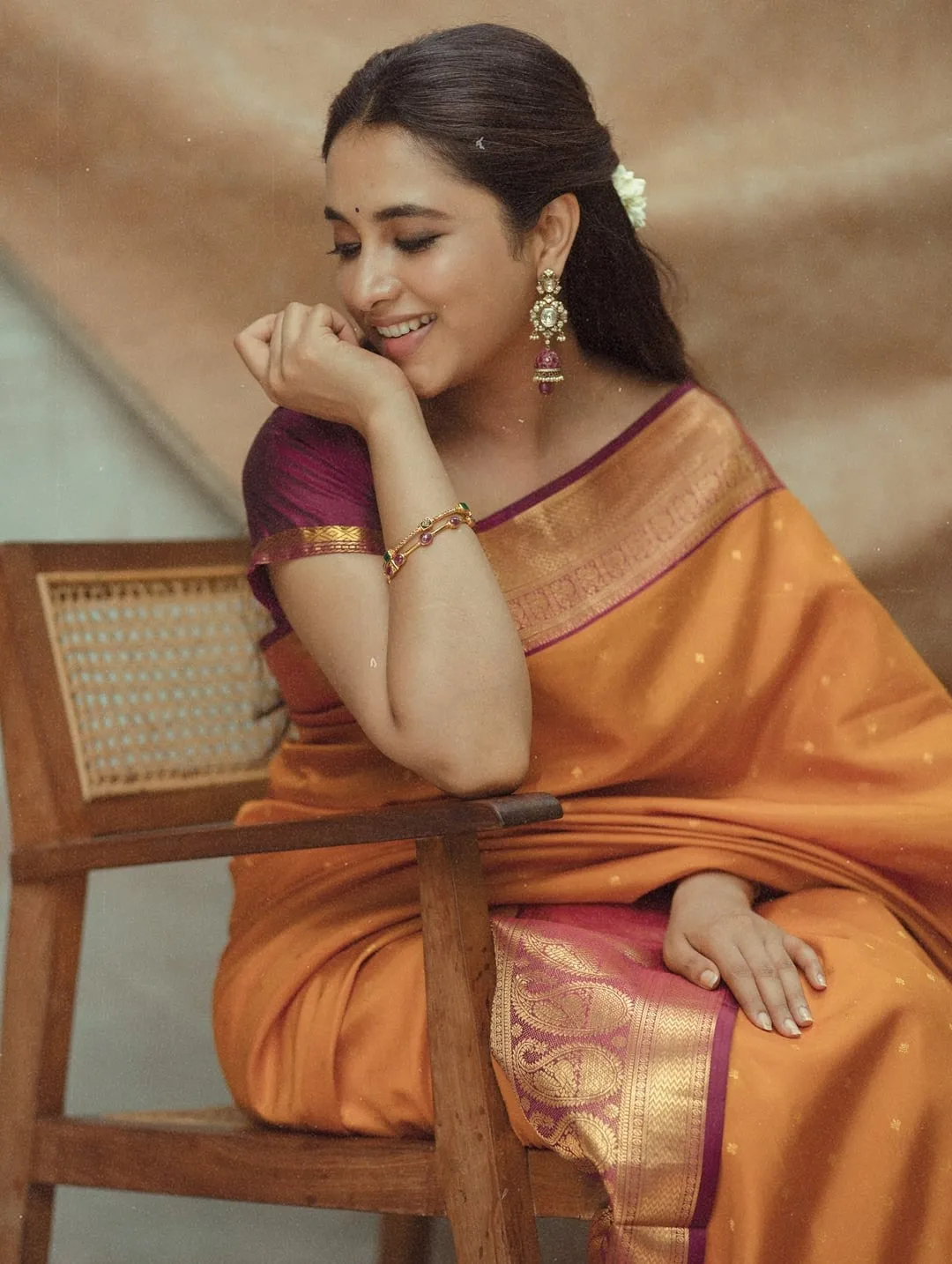Priyanka Mohan in Orange Saree Looking Down Pose in Studio