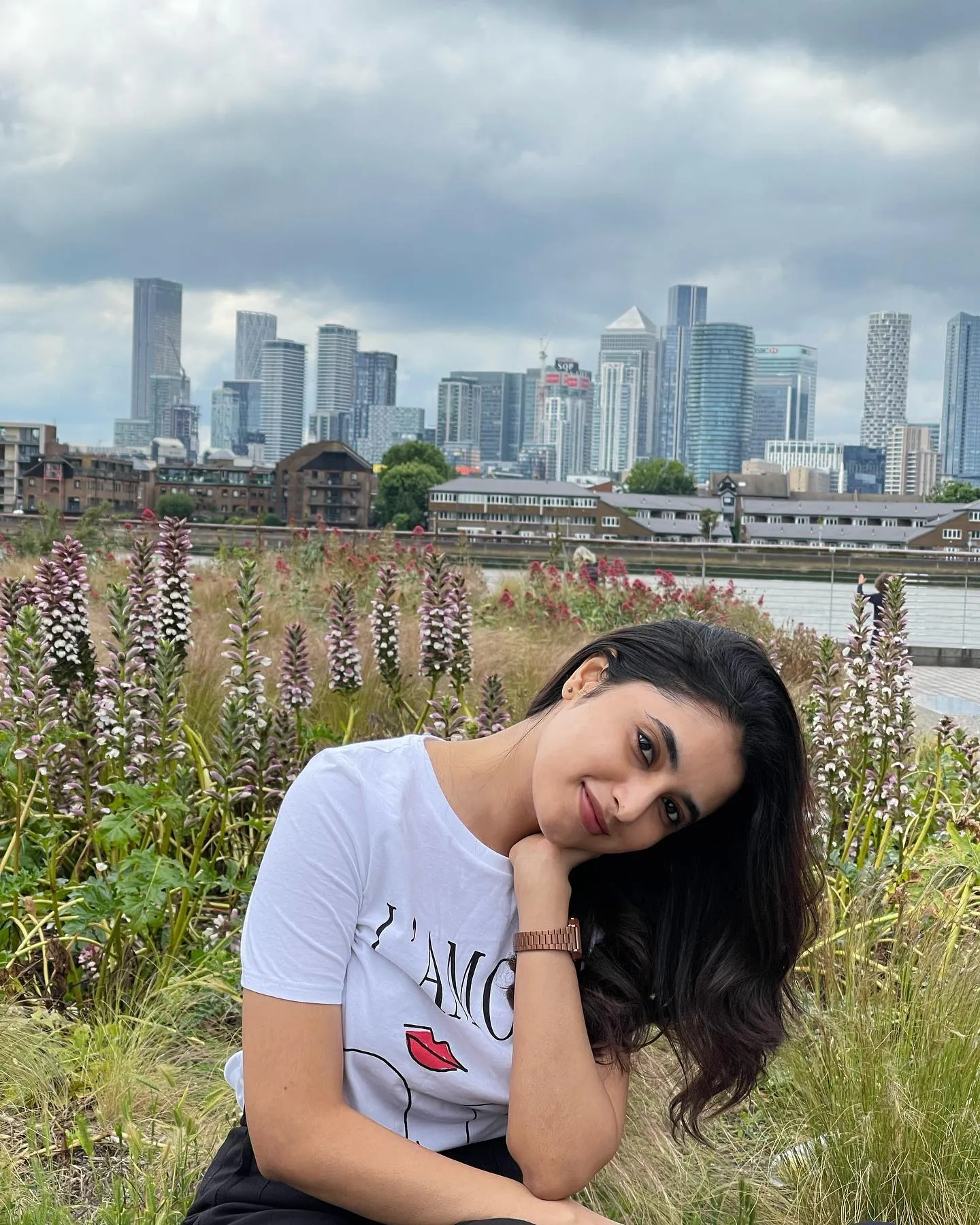 Priyanka Mohan in the Outdoors Near Flowers with a Cityscape