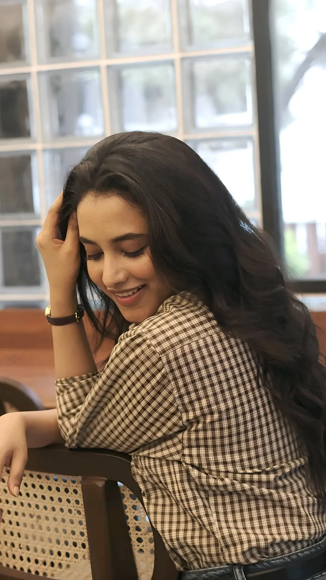 Priyanka Mohan Leaning on a Wooden Chair Wearing Plaid Shirt