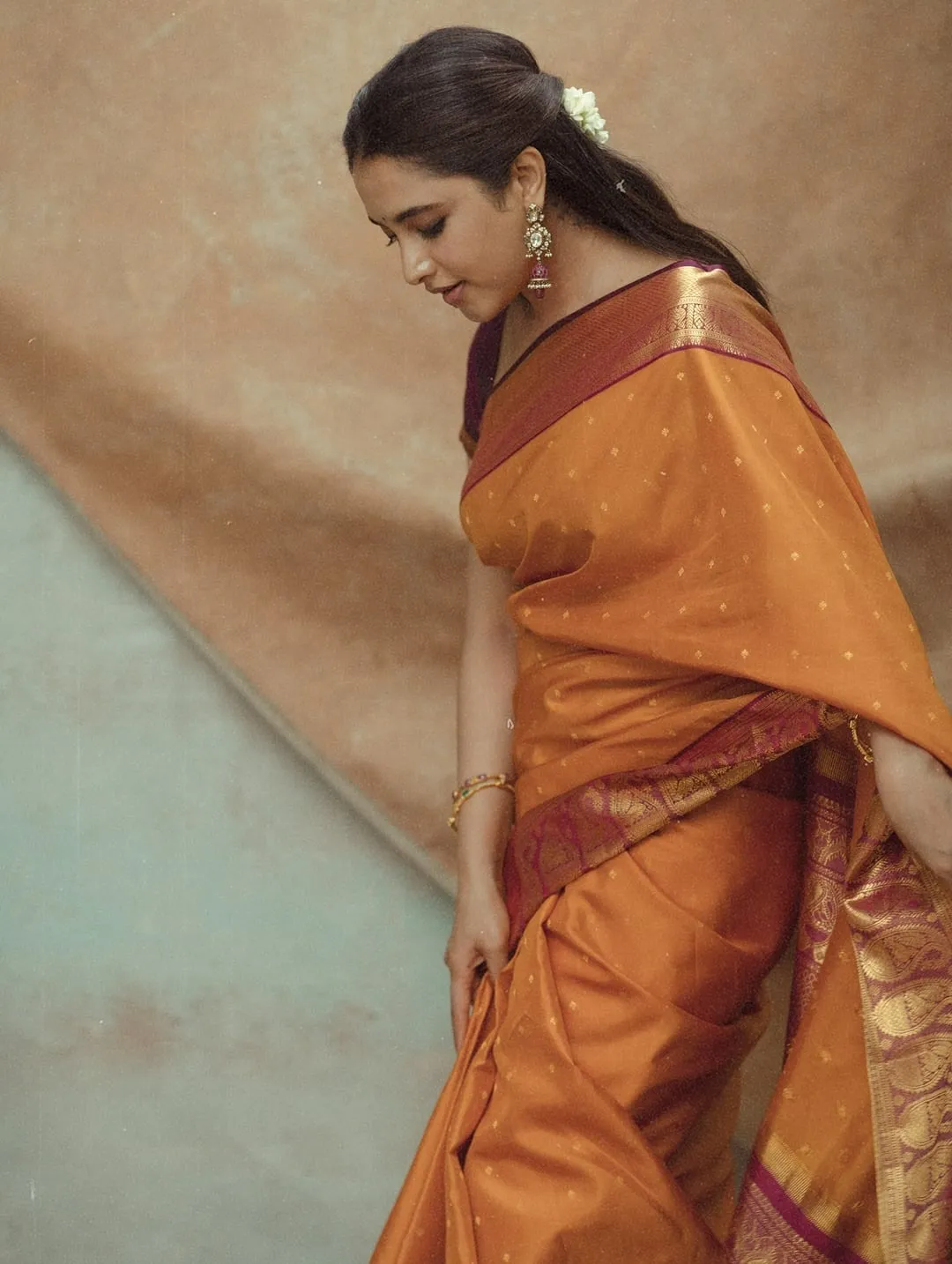 Priyanka Mohan Looking Down Pose Wearing an Orange Saree
