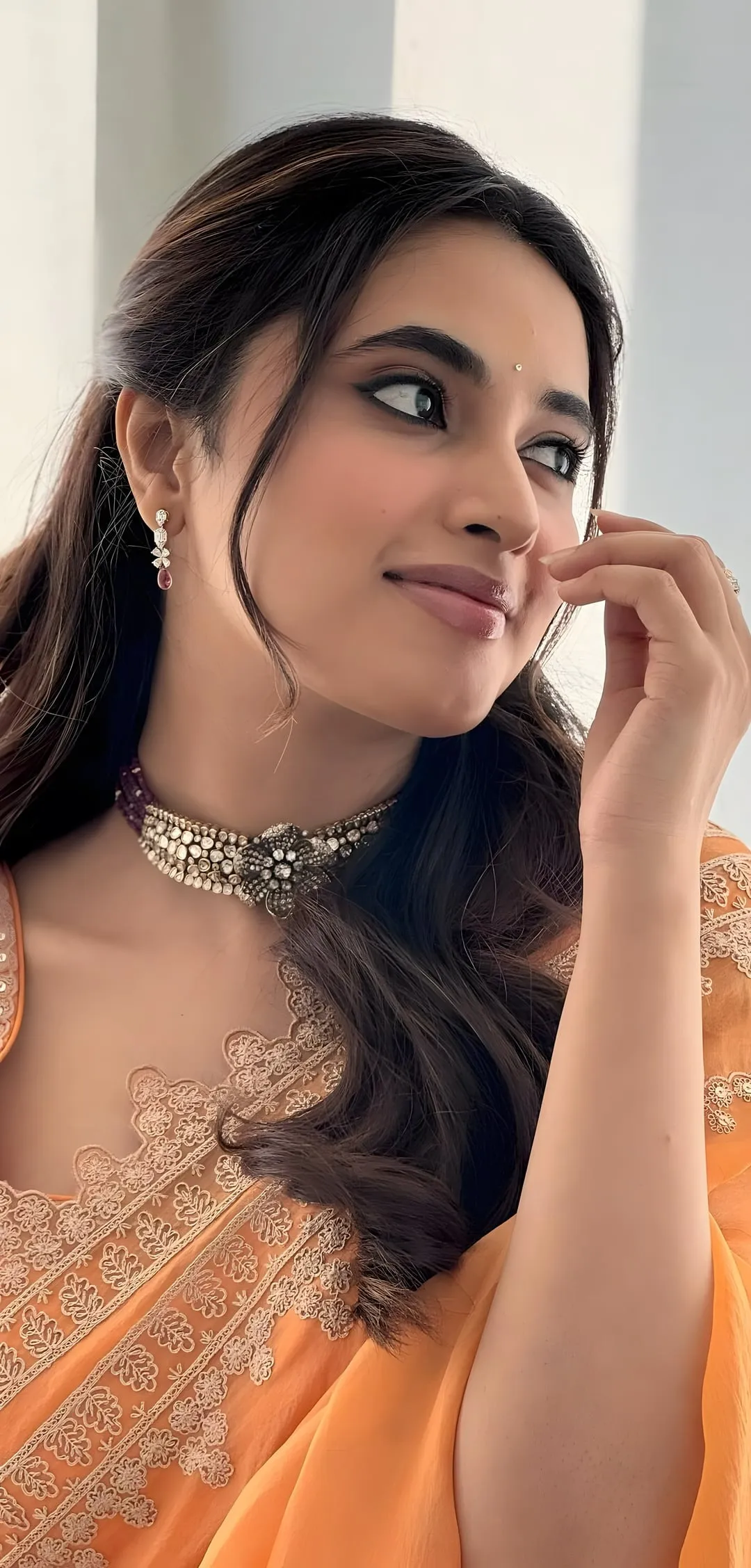 Priyanka Mohan Looking Sideways Wearing an Orange Saree