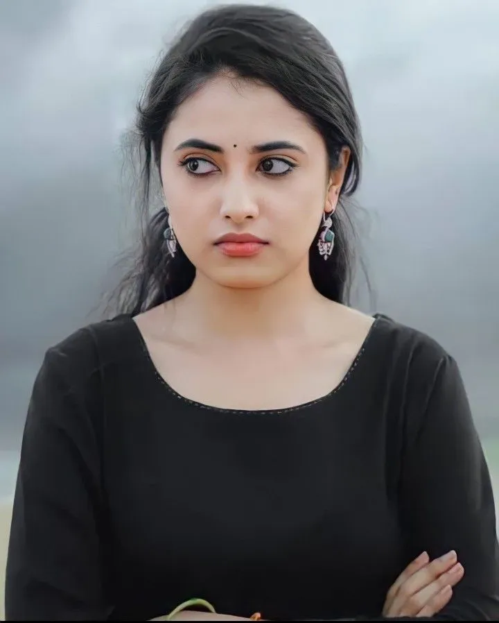 Priyanka Mohan serious look in black top with crossed arms