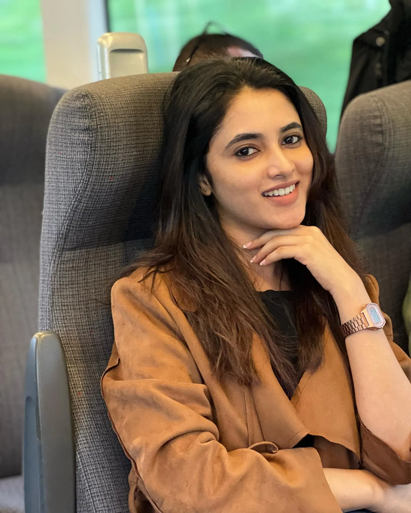 Priyanka Mohan Sitting in the Bus Wearing an Orange Outfit