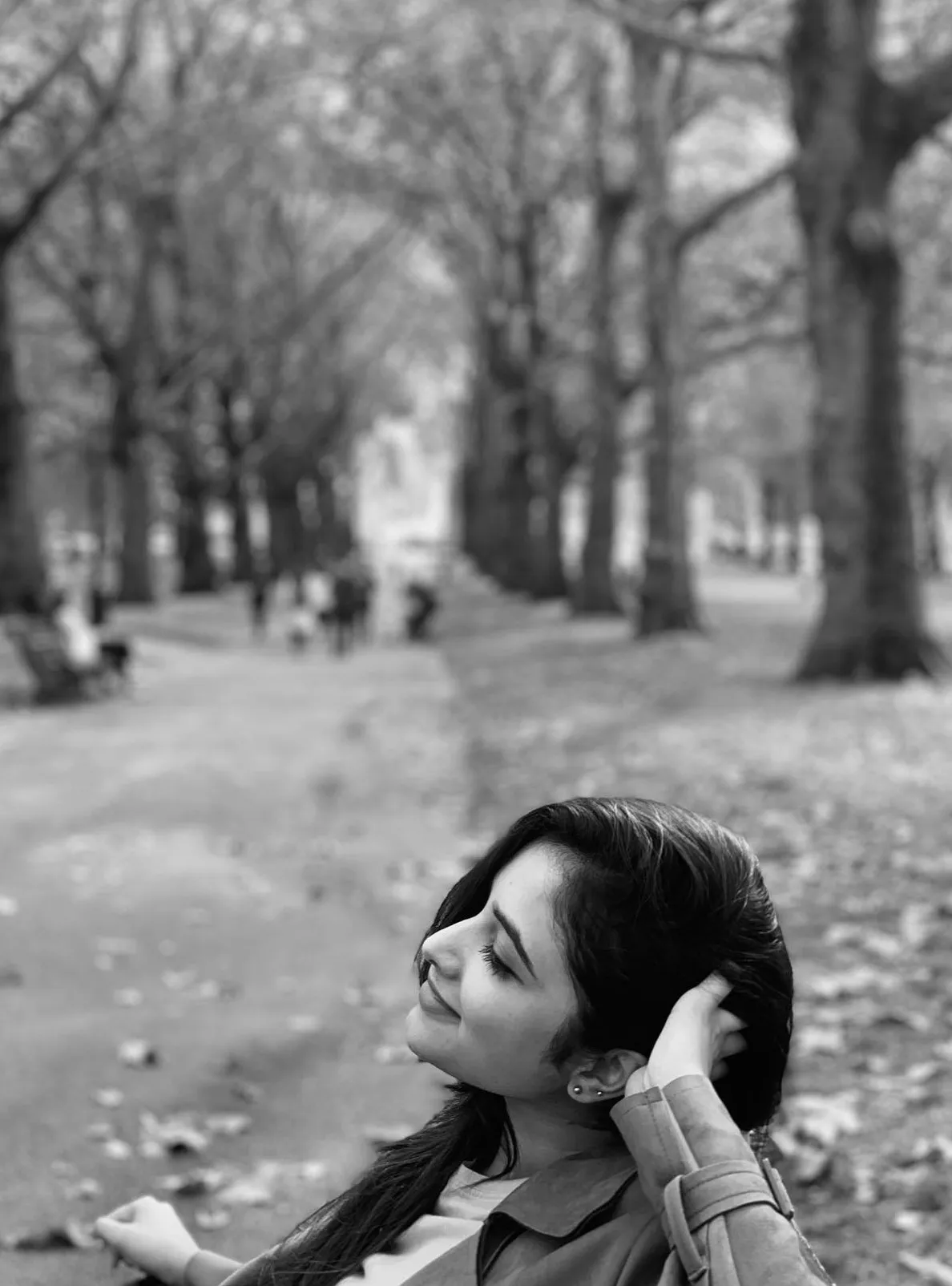 Priyanka Mohan Sitting on the Park Bench Near the Tall Trees