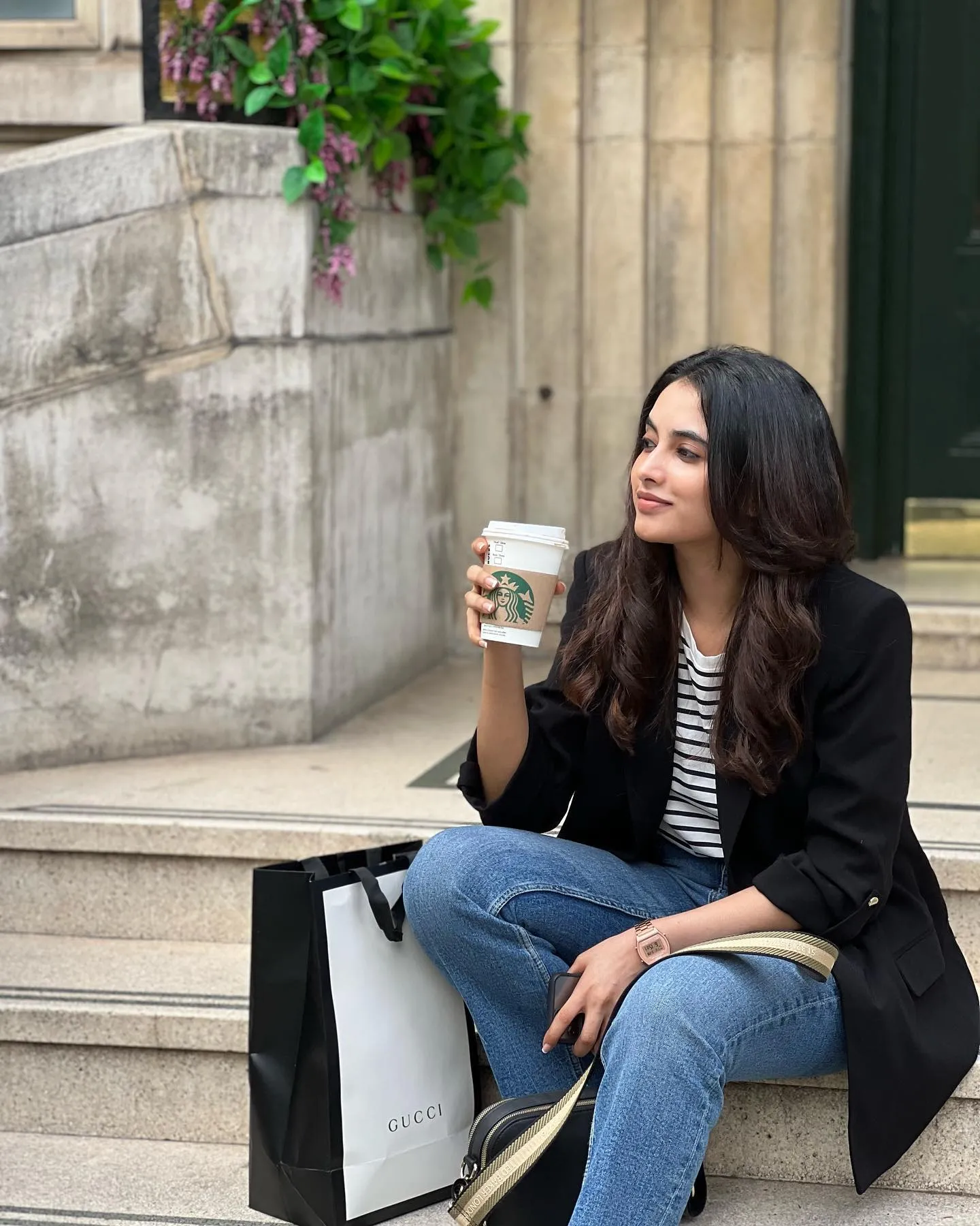 Priyanka Mohan Sitting on the Stairs Holding a Coffee Cup