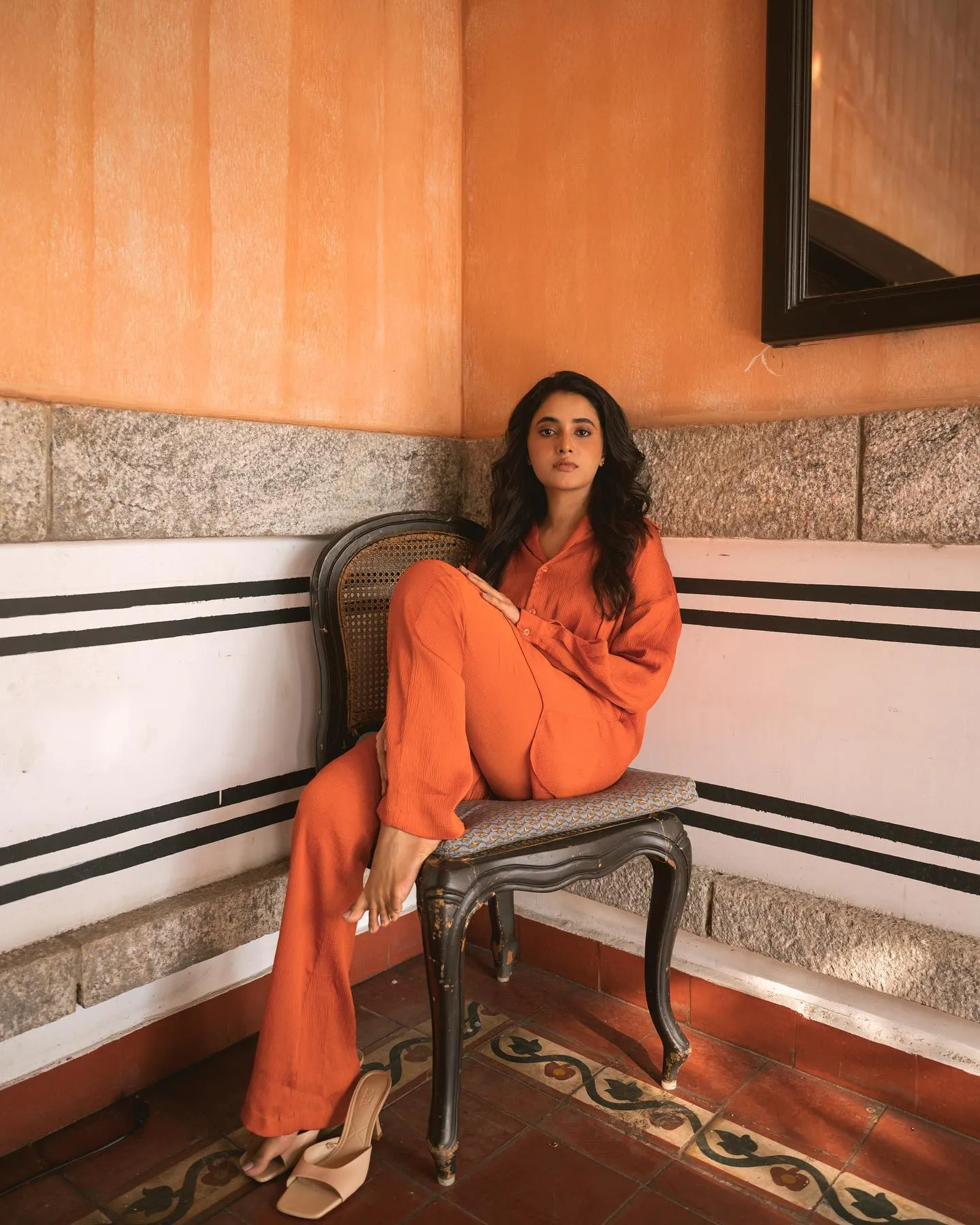 Priyanka Mohan Sitting on the Wooden Chair Near the Wall