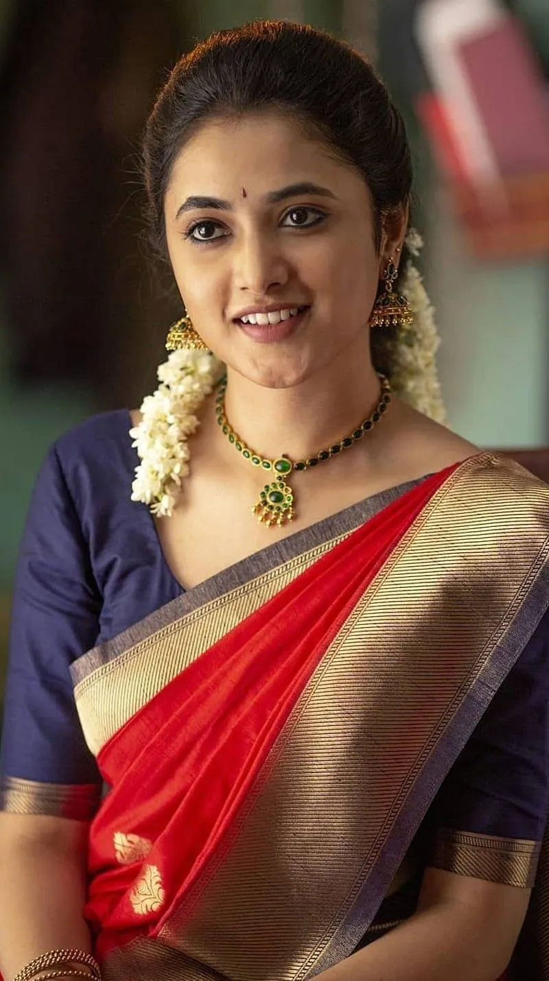 Priyanka Mohan smiling in traditional saree with flowers