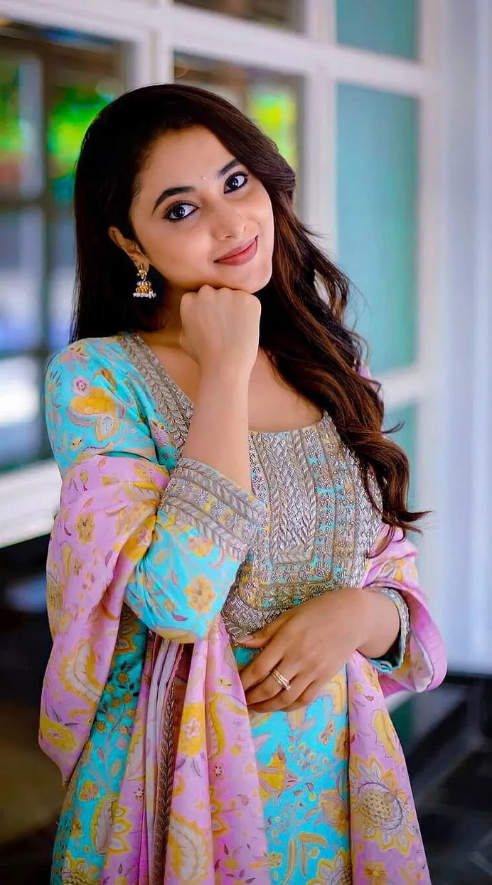 Priyanka Mohan Standing Near Glass Window Wearing Blue Dress
