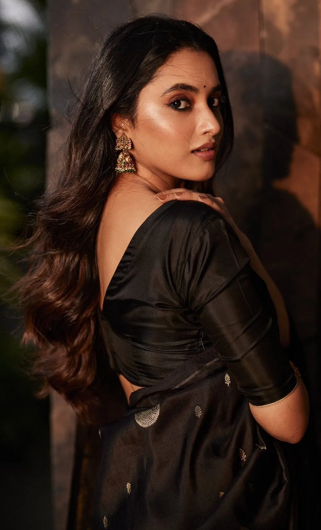 Priyanka Mohan Standing Outdoors Wearing a Black Saree