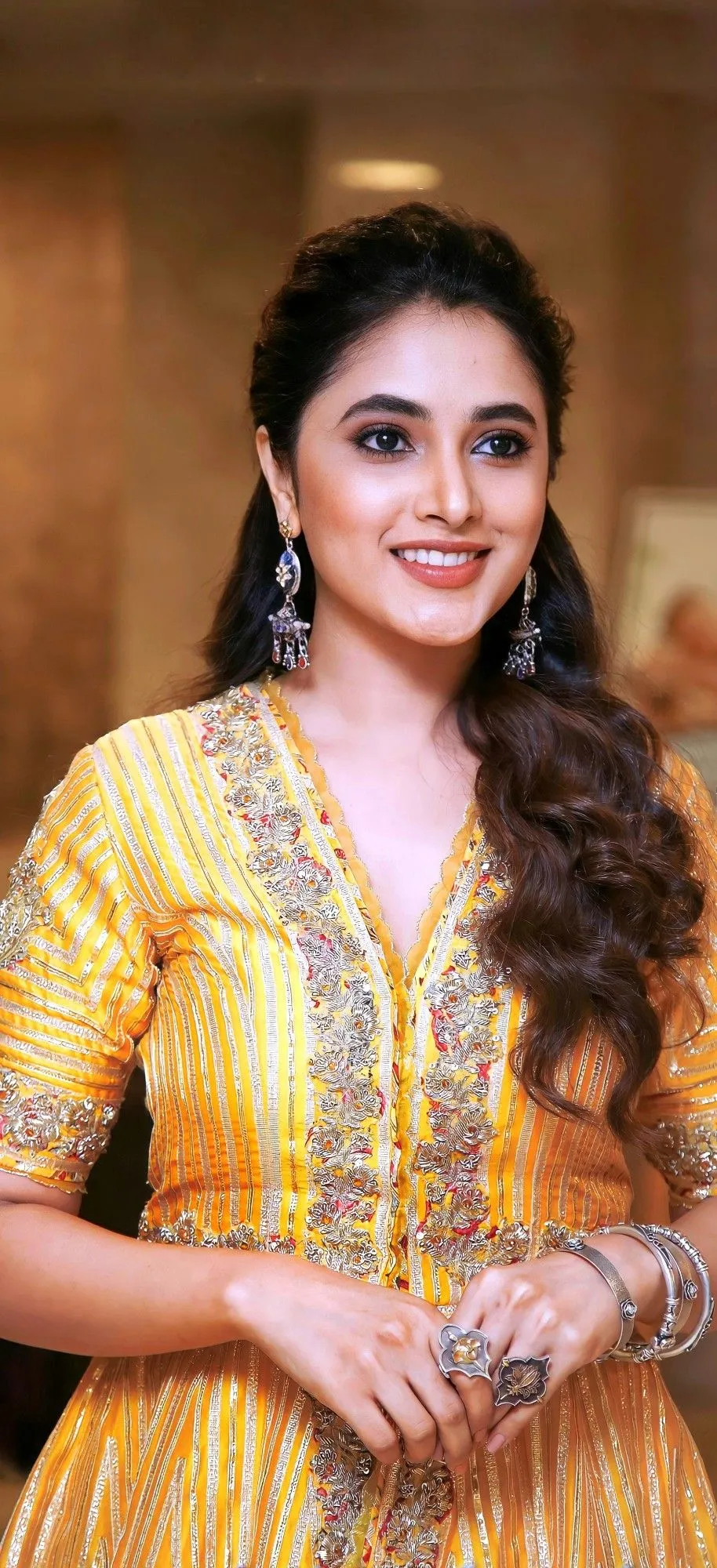 Priyanka Mohan with a Hand Holding Pose Wearing Yellow Dress