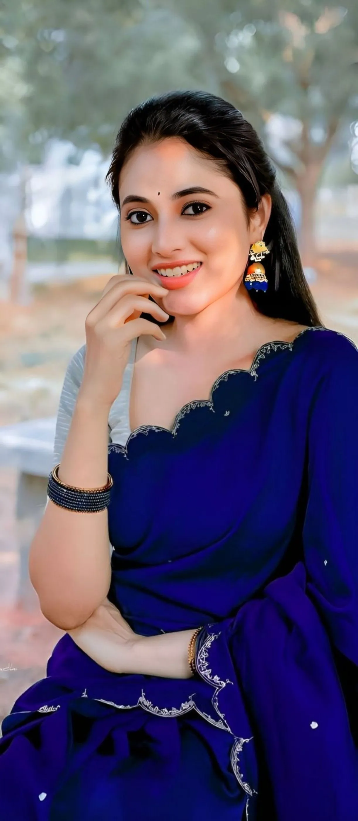 Priyanka Mohan with a Smile Sitting Outdoors Wearing a Saree