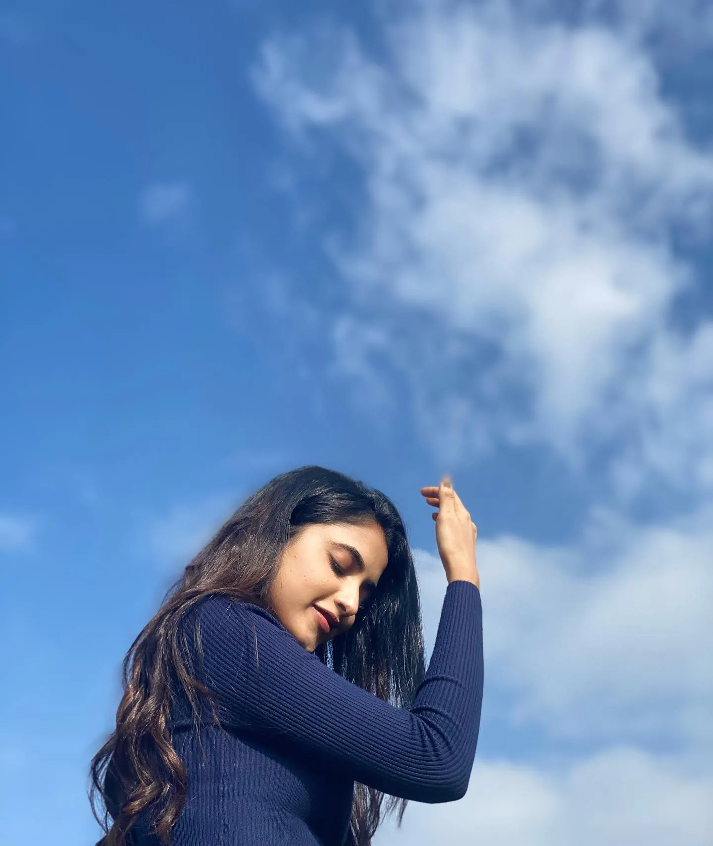 Priyanka outdoors with sky background and peaceful pose