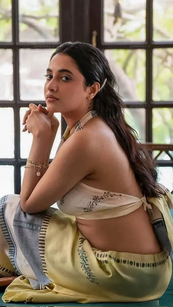 Priyanka sitting in gray and yellow traditional outfit image