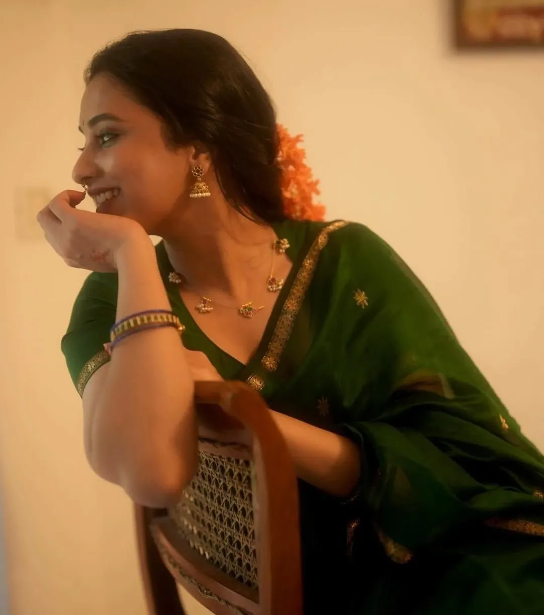 Priyanka smiling seated in green saree HD Wallpaper