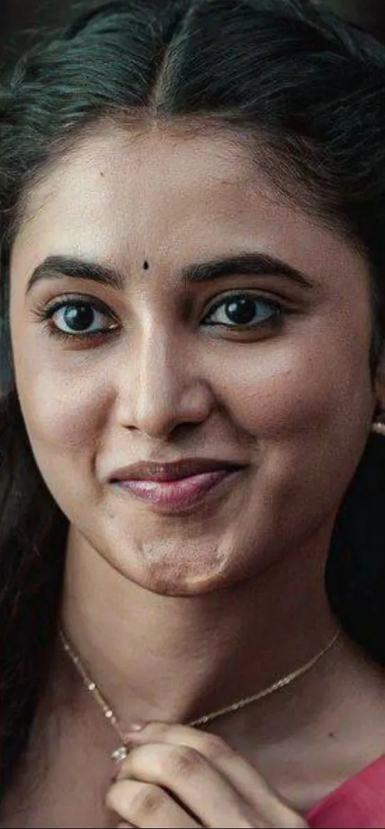 Priyanka smiling softly with traditional bindi and braid