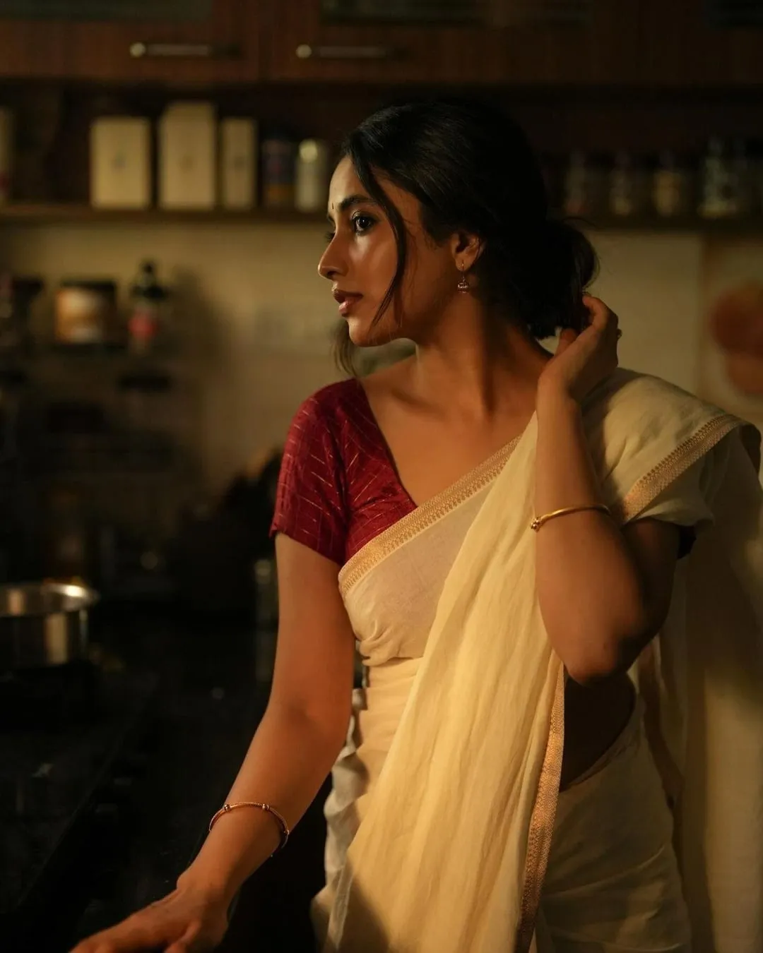 Priyanka Standing in a traditional kitchen scene Wallpaper