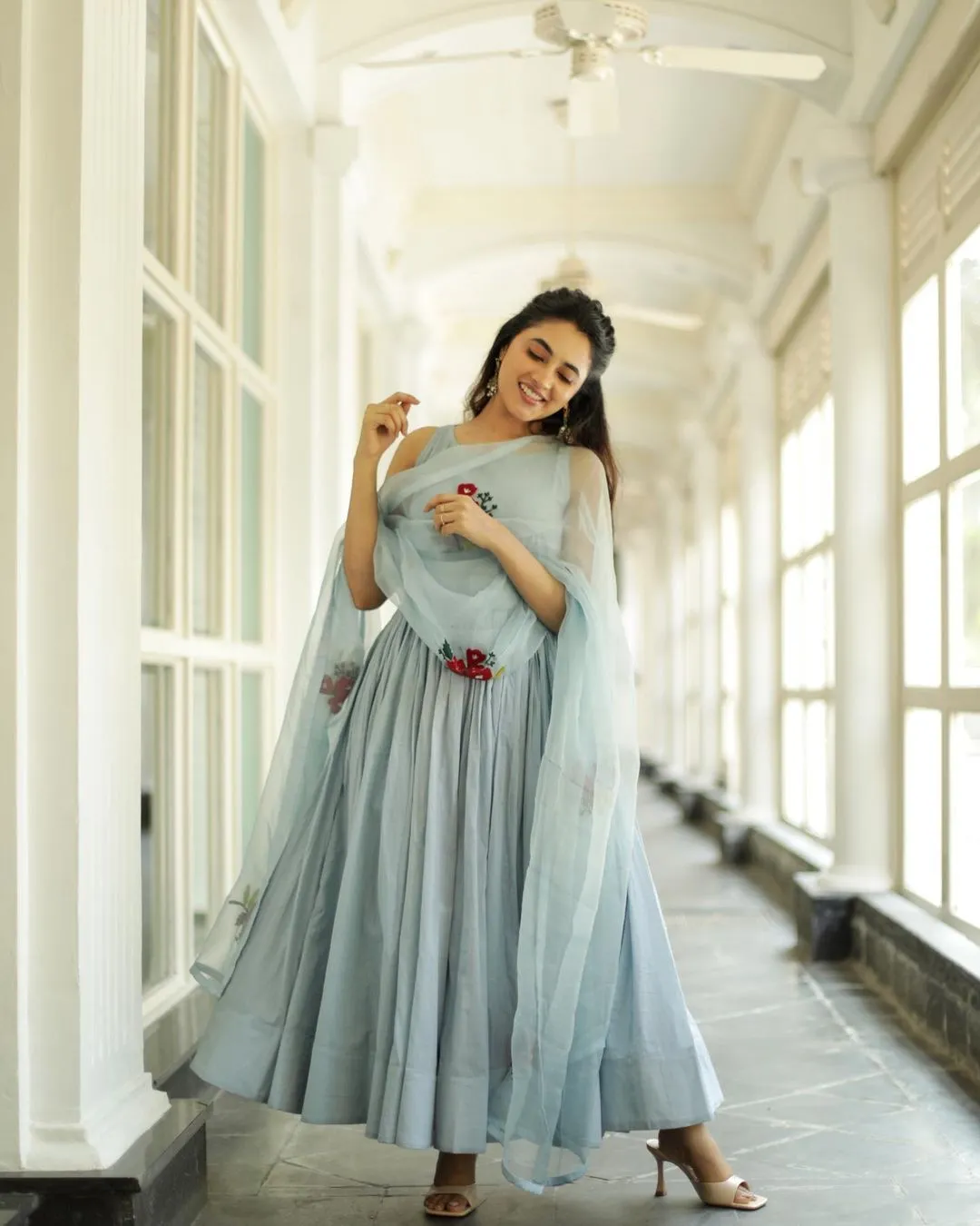 Priyanka twirling in grey gown in bright hallway Wallpaper