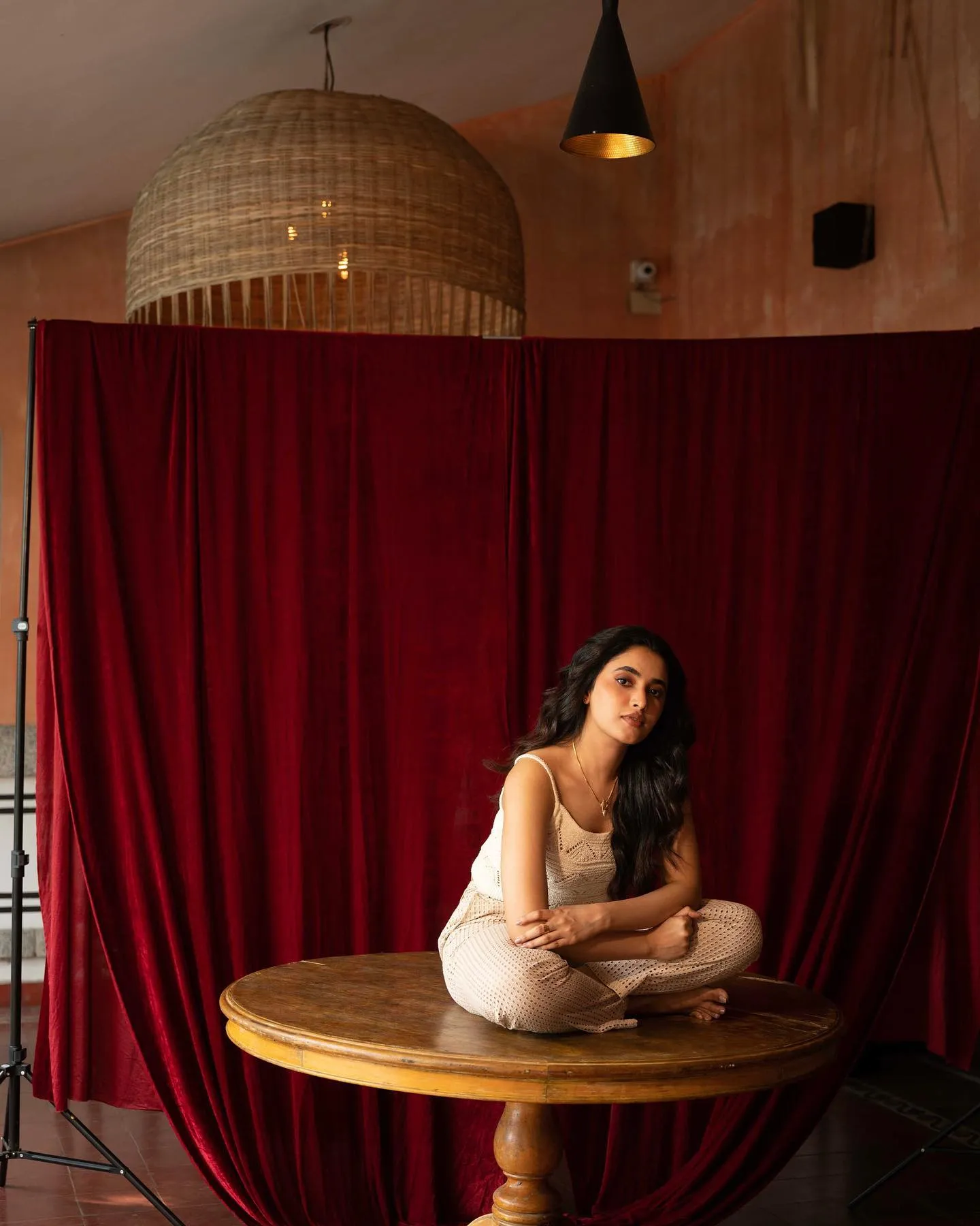 Serene Priyanka Arul Mohan Sitting on Wooden Table Wallpaper
