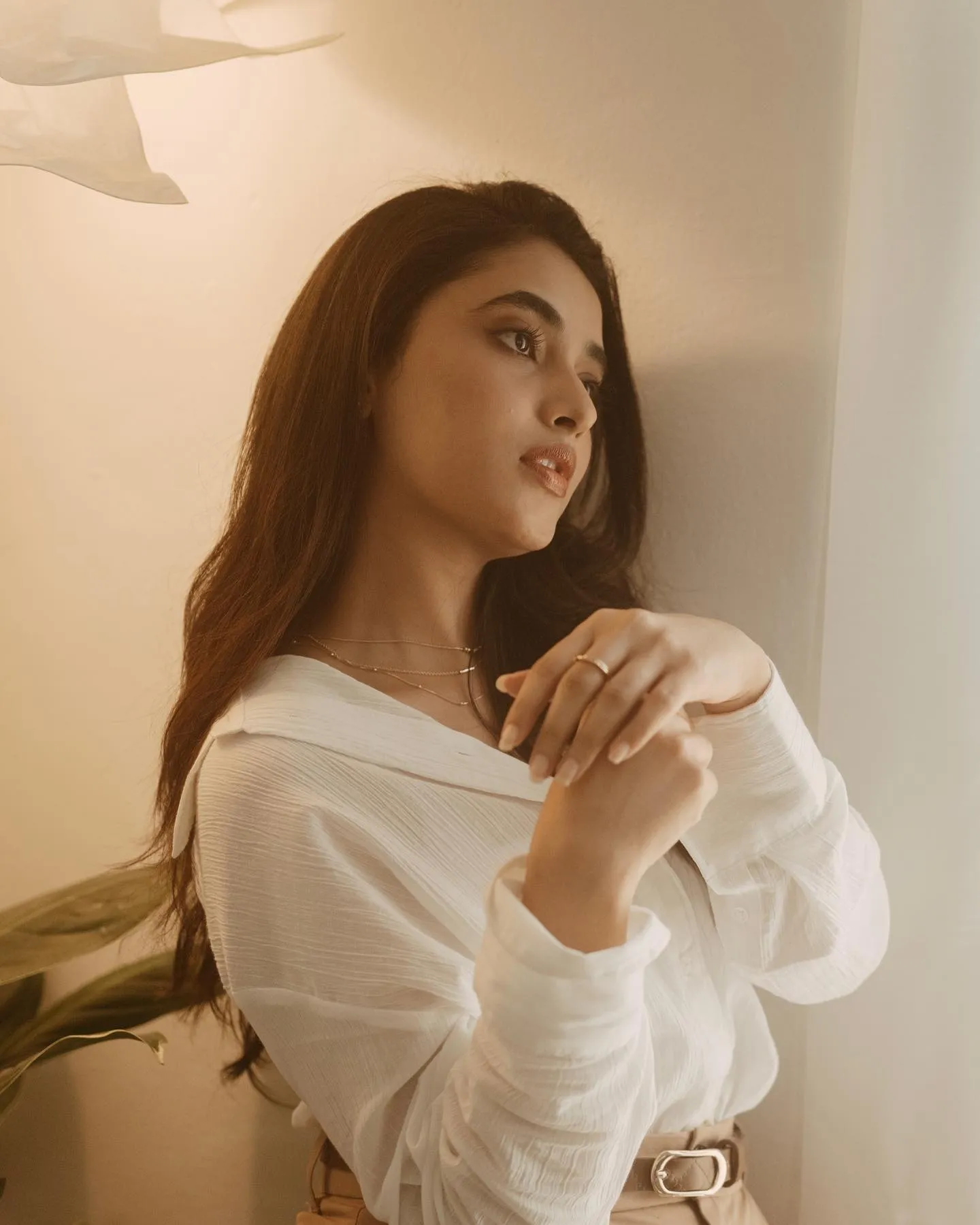 Soft and elegant Priyanka in white shirt near window image