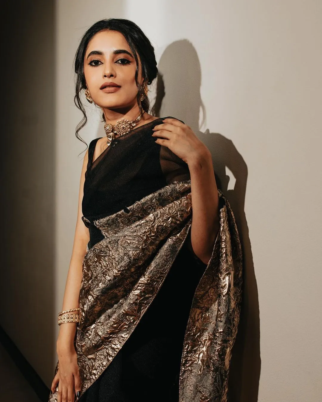 Striking Image of Priyanka Mohan in a Black Saree Near Wall