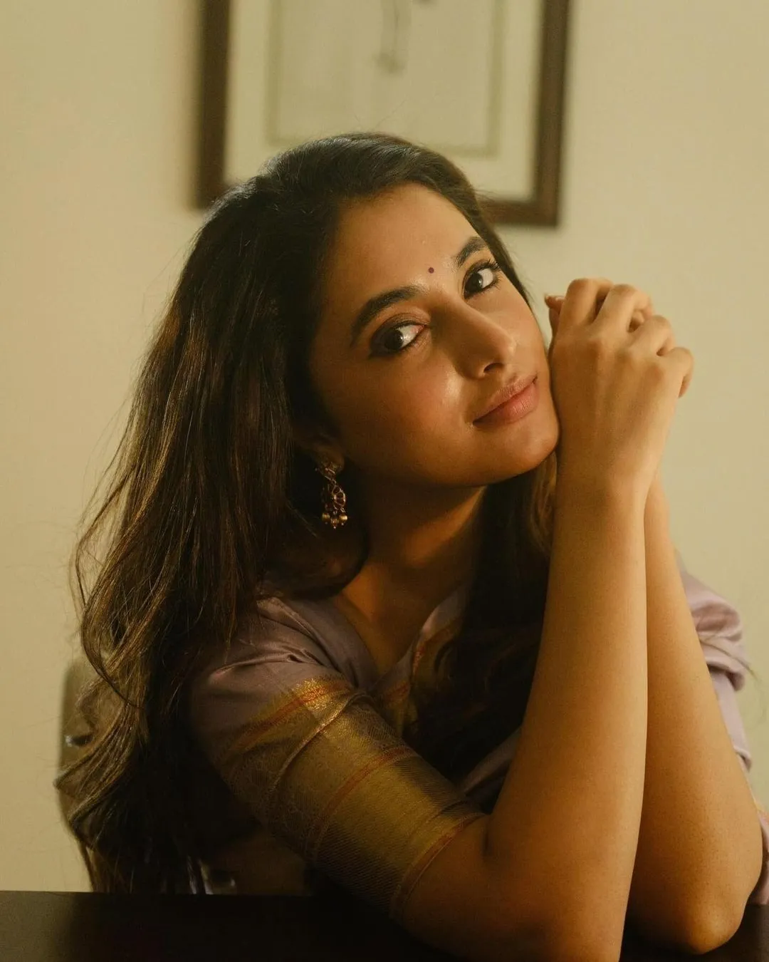 Thoughtful Priyanka Arul Mohan Leaning on Hands Wallpaper