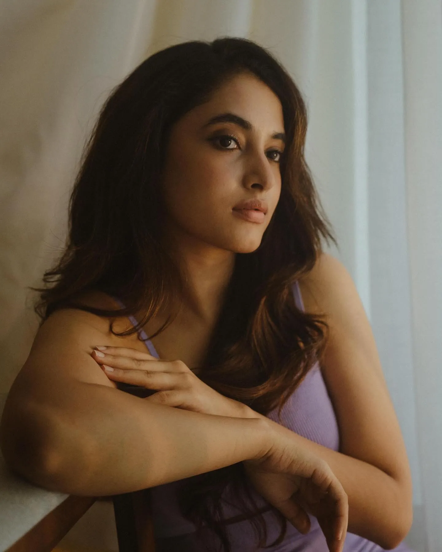 Thoughtful Priyanka looking outside with purple dress