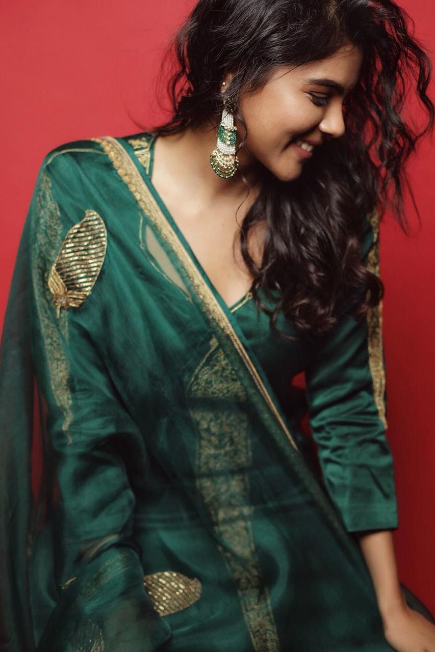 Green Dress Look of Kalyani Priyadarshan with Red Background