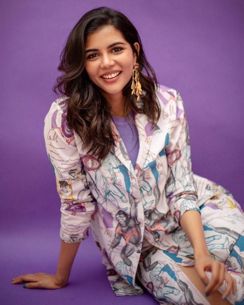 Happy Kalyani in Printed Outfit on Purple Backdrop Image