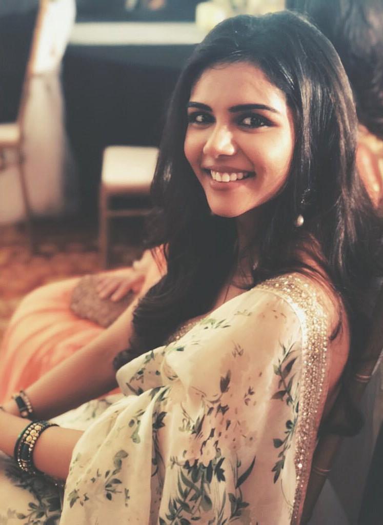 Happy Kalyani Sitting in Floral Dress with Bright Smile Shot