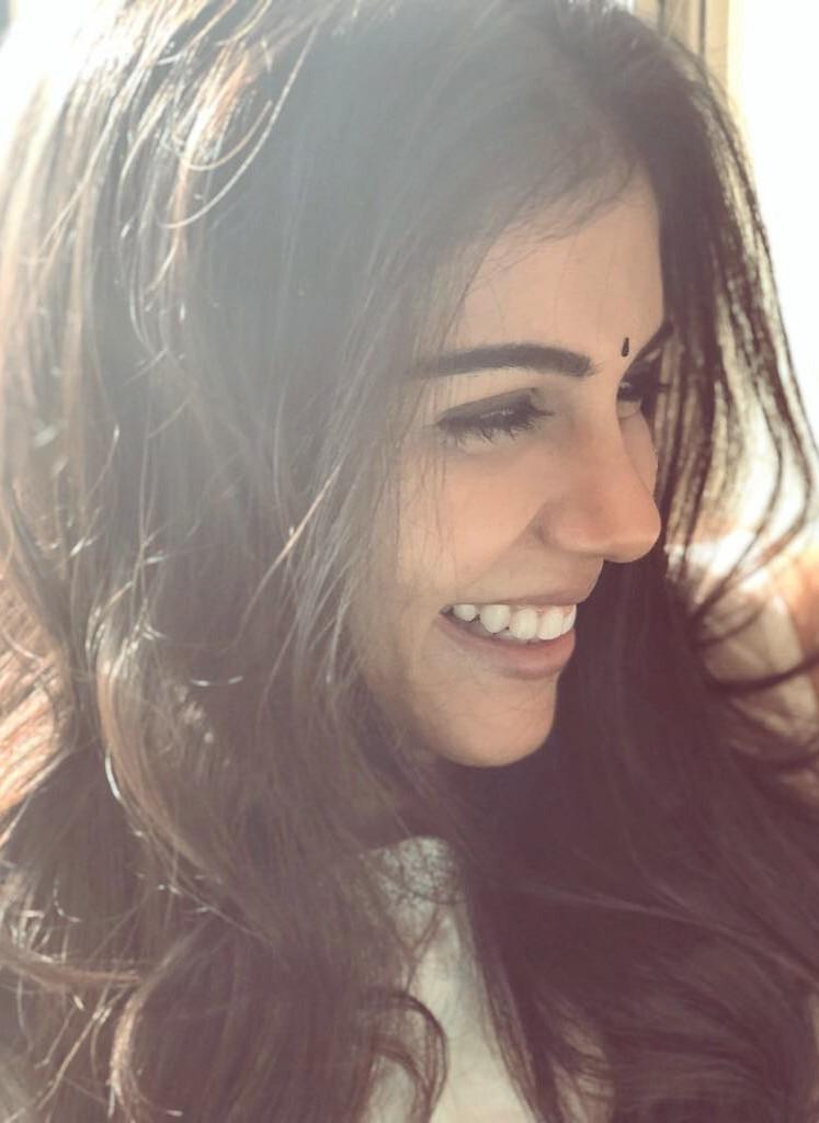 Happy Kalyani with Flowing Hair Smiling in Soft Light Image
