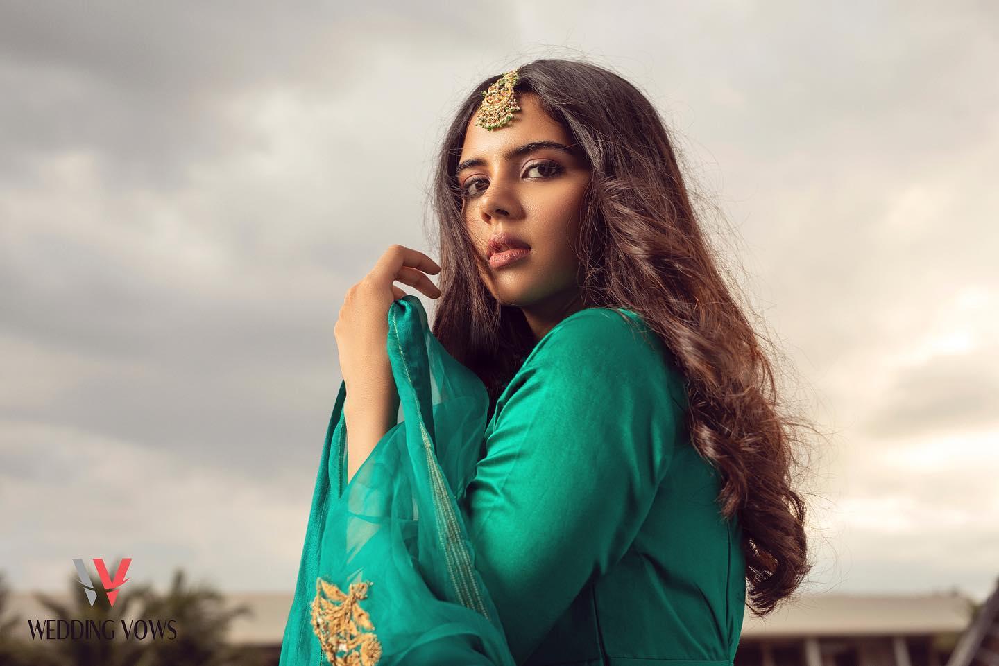 Kalyani Green Traditional Outfit with Cloudy Sky Backdrop