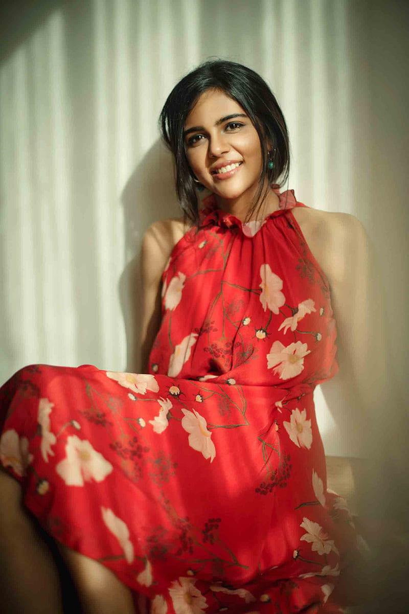 Kalyani in Red Floral Dress Sitting by Window free Image