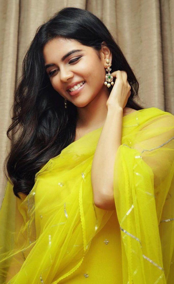 Kalyani in Yellow Saree Smiling with Hand on Hair free Image