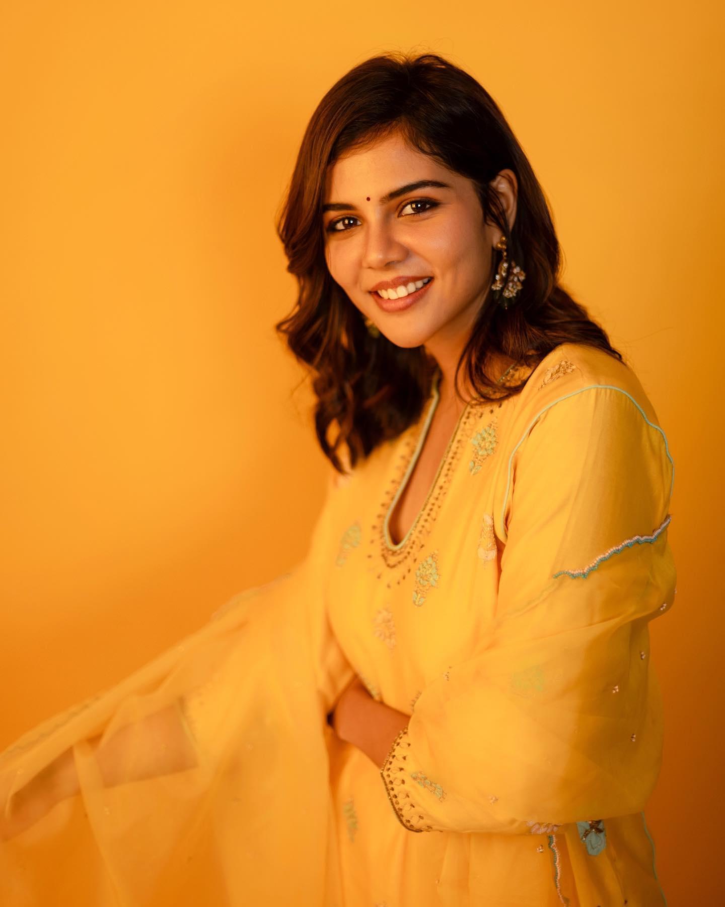 Kalyani in Yellow Traditional Dress with Orange Background
