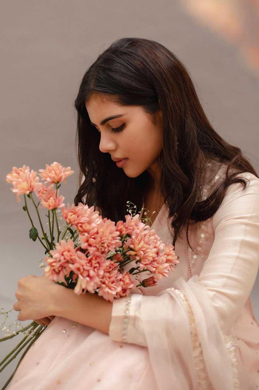 Kalyani Priyadarshan Holding Flowers in Pastel Dress Image