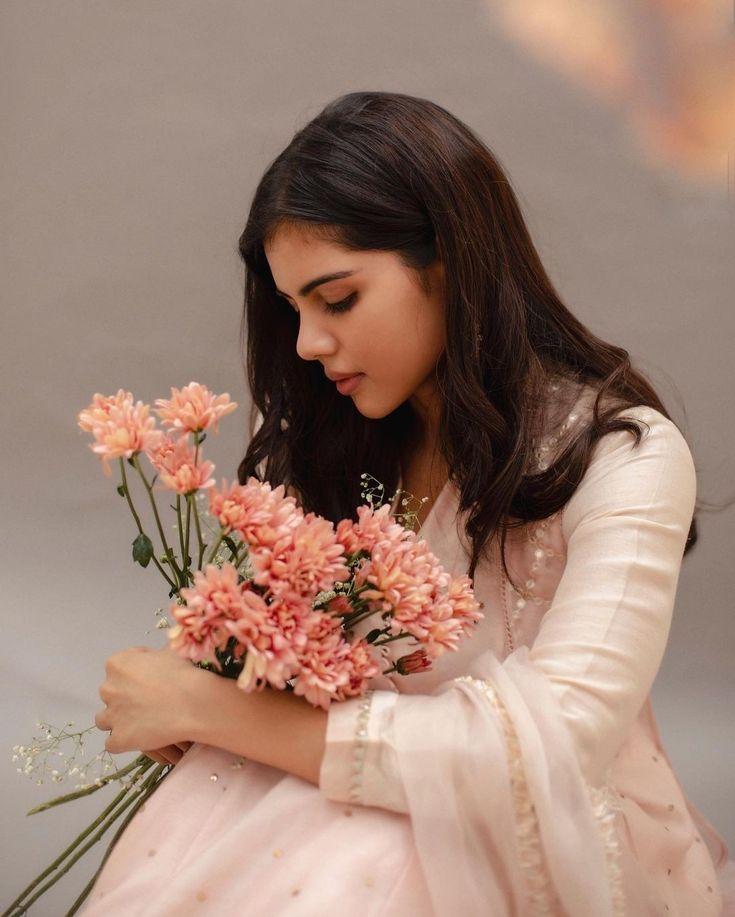Kalyani Priyadarshan Holding Flowers in Pink Dress Image