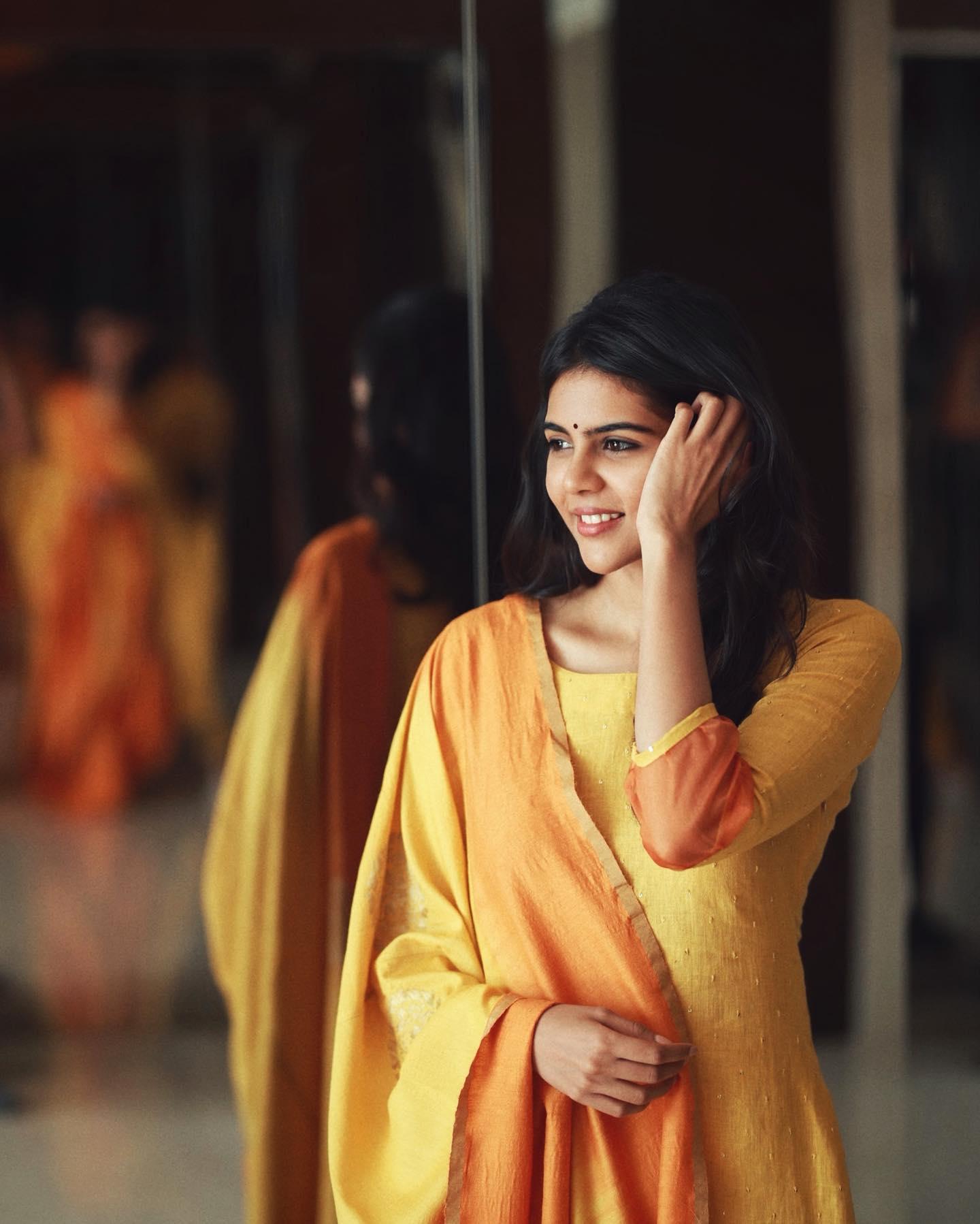 Kalyani Priyadarshan in a Yellow Orange Dress Image