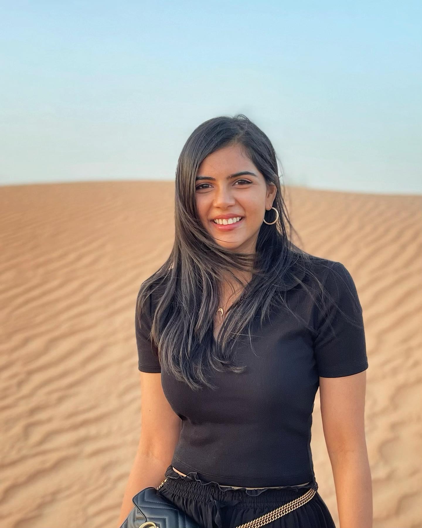 Kalyani Priyadarshan in Black Dress Walking in Desert Image