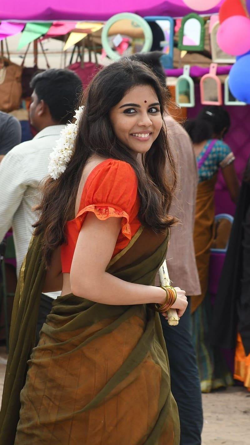 Kalyani Priyadarshan in Brown Saree Smiling at Event Pic