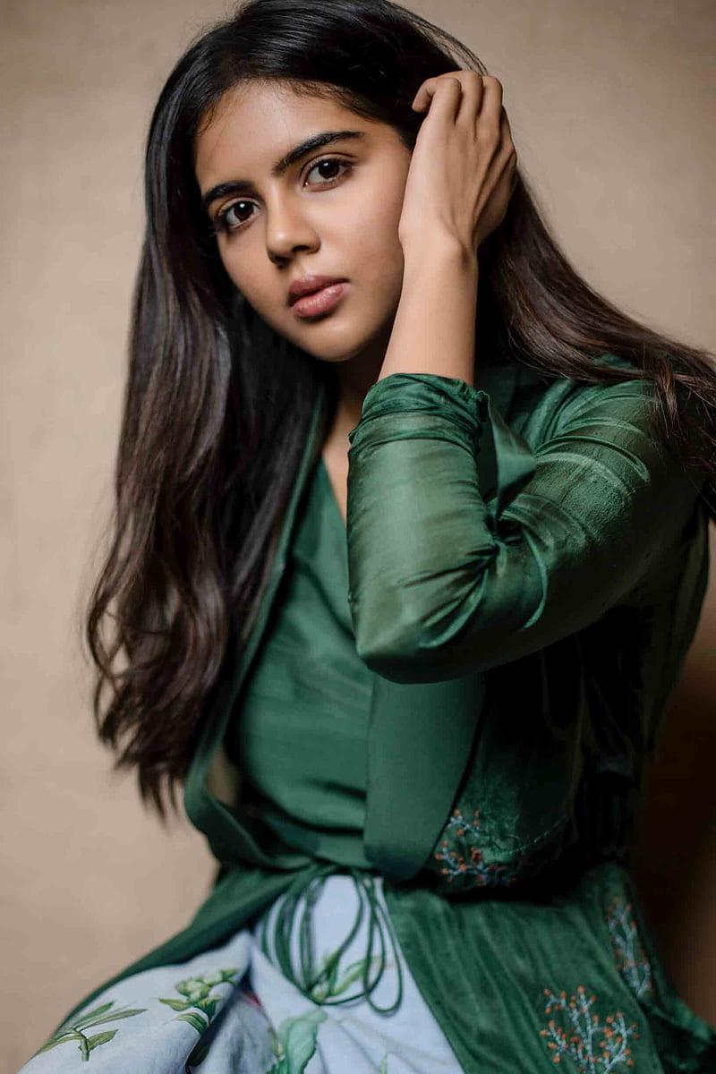Kalyani Priyadarshan in Green Top with Hand in Hair Image