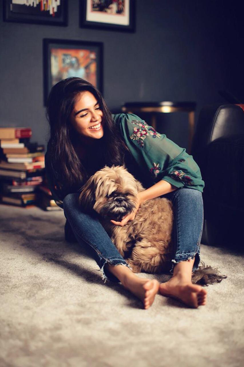 Kalyani Priyadarshan Playing with Pet Theo Cute Image