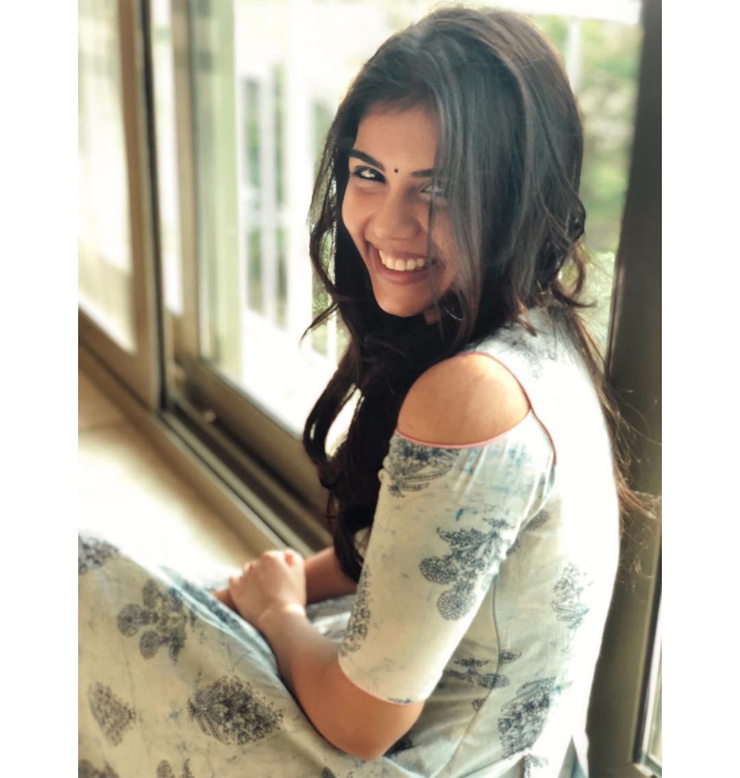 Kalyani Priyadarshan Sitting Near Window in Dress Image